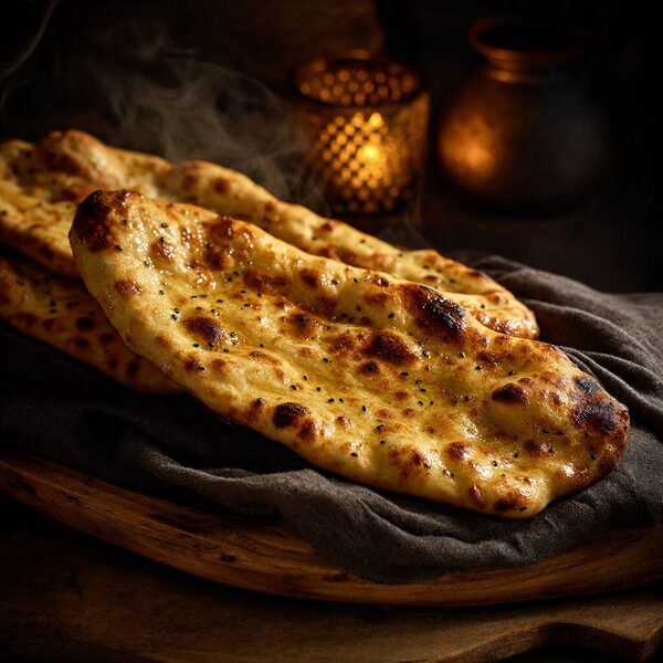 Illustrative Afghan flatbread with a blistered crust, stacked on dark linen